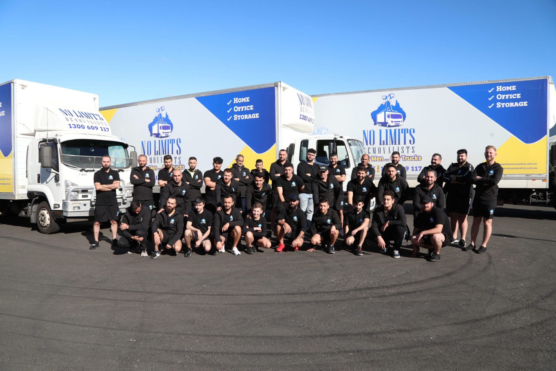 The No Limits Removalists crew in front of the company trucks
